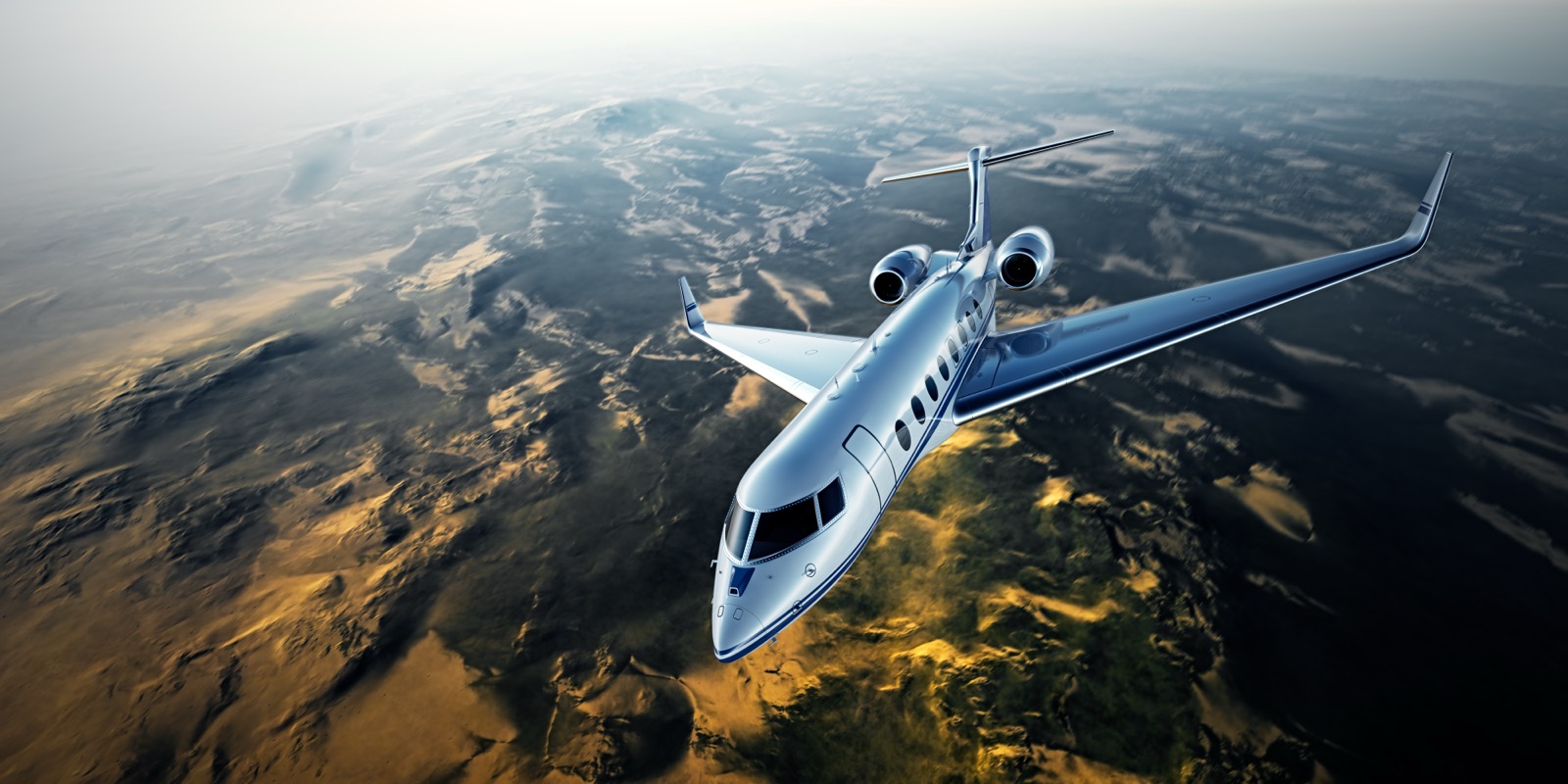 Private jet in flight over open landscape